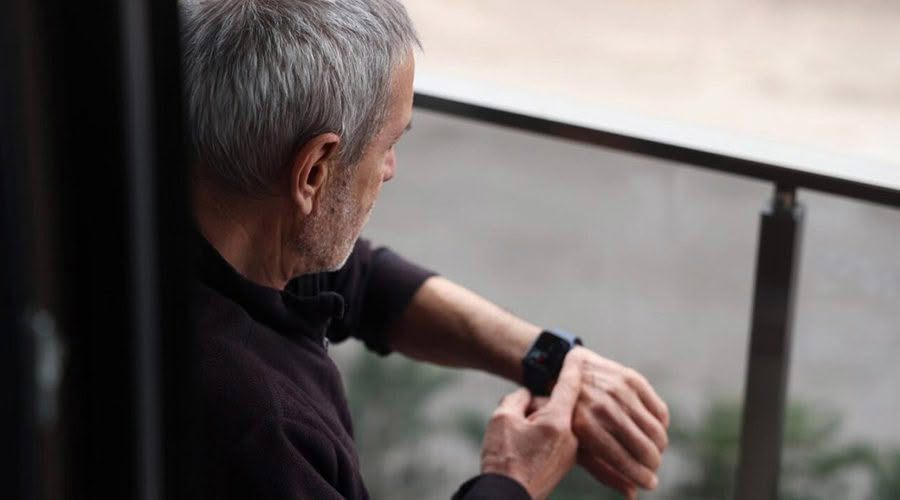 man looking at smart watch