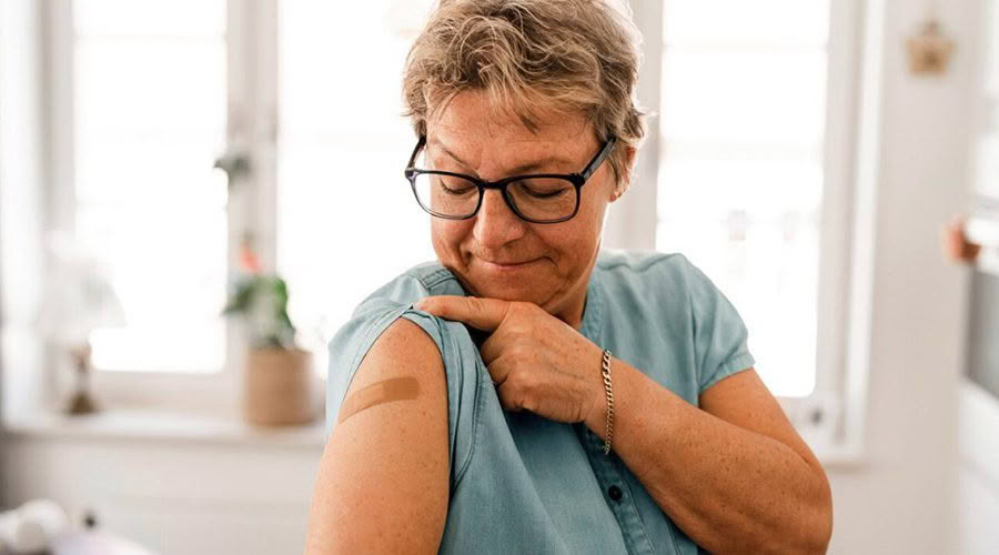 older women getting a covid 19 vaccination